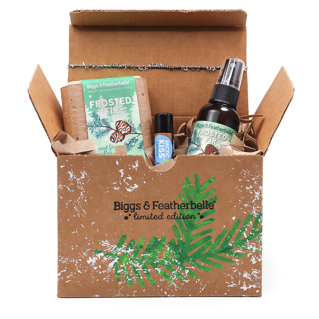 Opened Frosted Fir Custom Gift Box by Biggs & Featherbelle® with products peeking out.